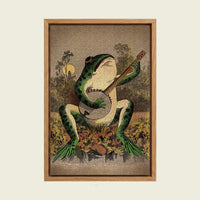 A Frog Playing Banjo in the Moonlight canvas wall art in a floating oak frame