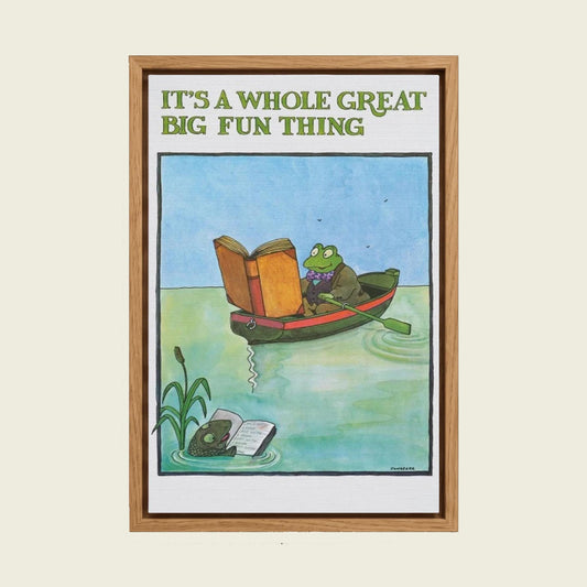Frog Reading a Book by Tomi Ungerer canvas wall art in a floating oak frame