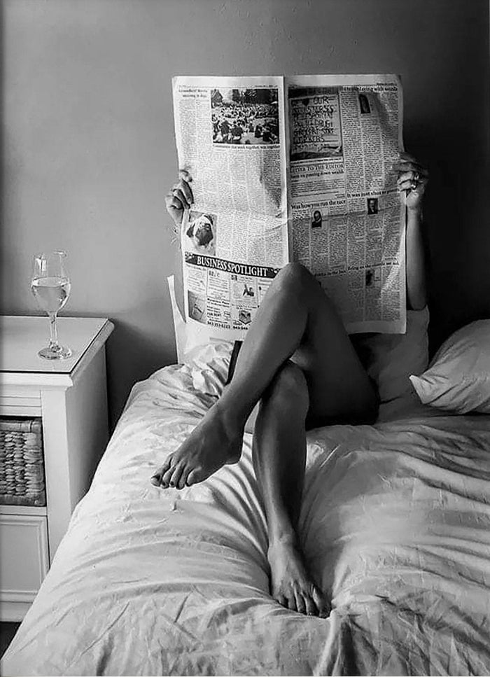 Woman Reading Newspaper in Bed Black and White Canvas Art